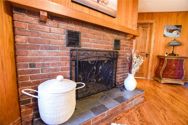 532 W Sunbury Rd, Center Twp But, PA 16001 - room details with wooden walls, a fireplace, and hardwood / wood-style flooring