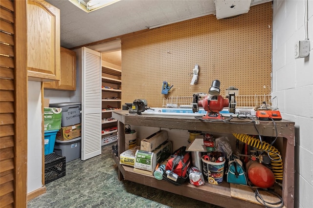 interior space with a workshop area and concrete block wall