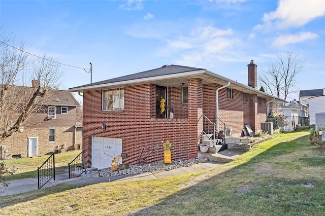 back of house with a garage, cooling unit, and a lawn