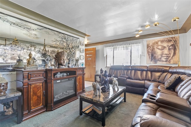 carpeted living area featuring a glass covered fireplace