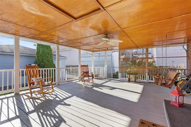 sunroom featuring wood ceiling and ceiling fan