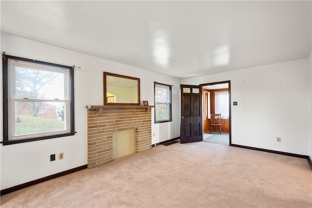 interior space featuring light colored carpet and a brick fireplace