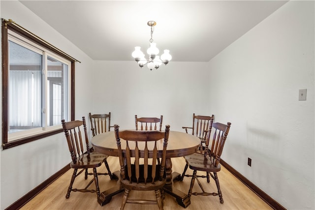 dining area with a chandelier and light wood-type flooring