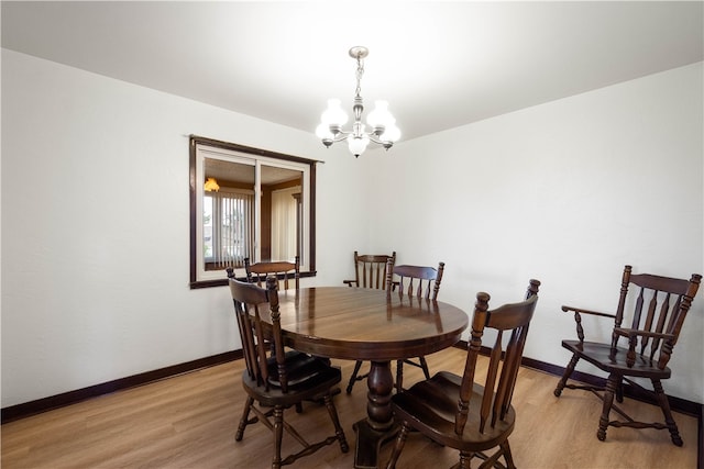 dining room with a notable chandelier and light hardwood / wood-style flooring