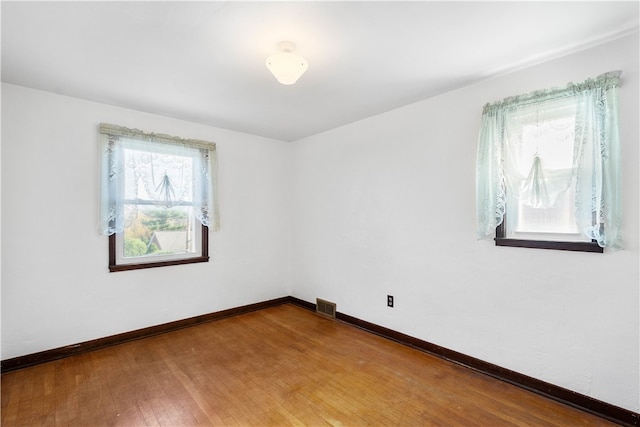 unfurnished room with wood-type flooring