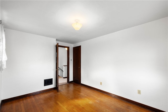 unfurnished room featuring wood-type flooring