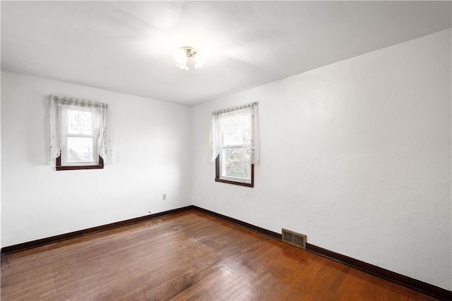 empty room featuring hardwood / wood-style floors and a healthy amount of sunlight