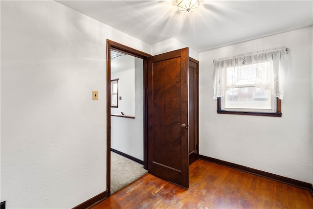 unfurnished bedroom featuring dark hardwood / wood-style flooring