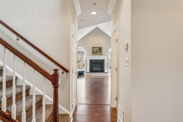 entryway featuring high vaulted ceiling, dark hardwood / wood-style floors, and crown molding