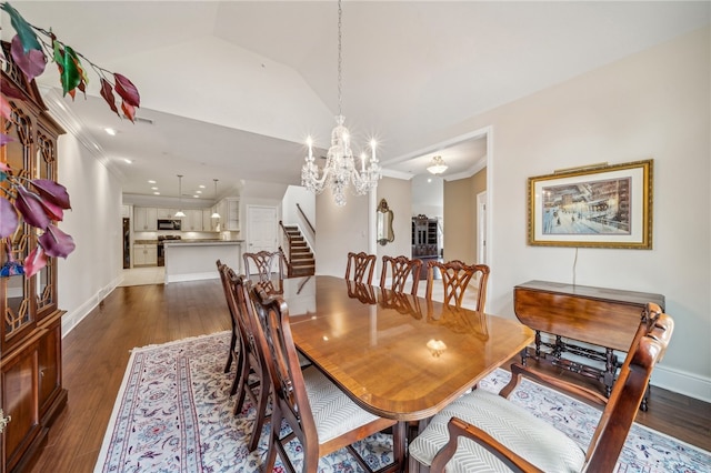 dining space with crown molding, lofted ceiling, dark hardwood / wood-style floors, and a chandelier