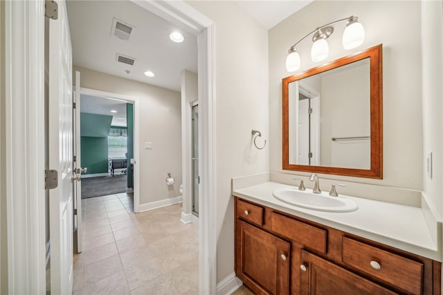 bathroom featuring tile patterned flooring, vanity, and toilet