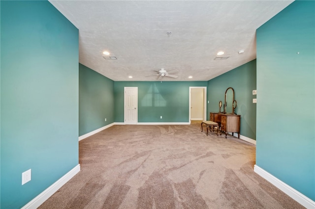 unfurnished room with ceiling fan and carpet flooring