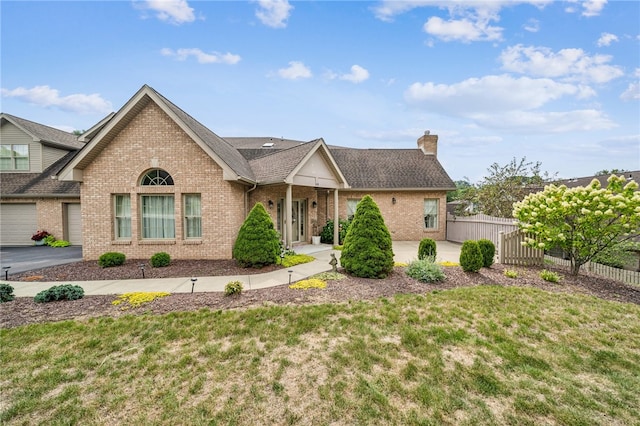 view of front of property with a garage and a front lawn