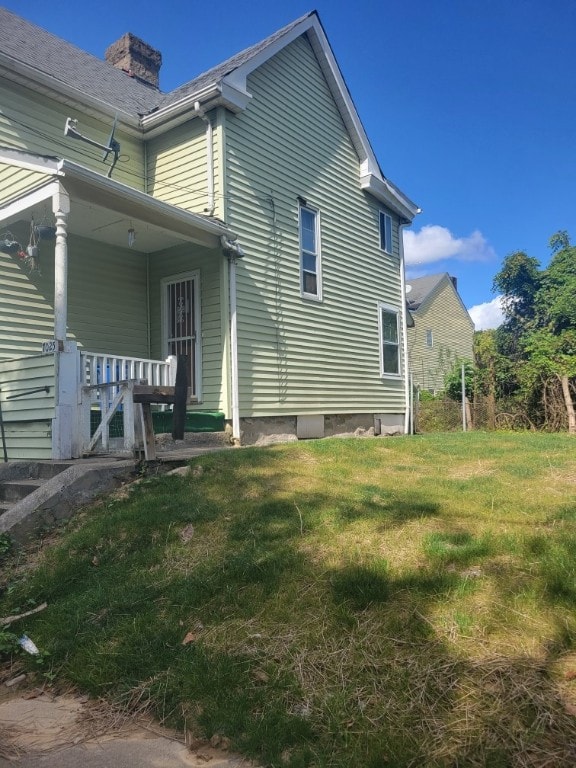 view of home's exterior with a lawn