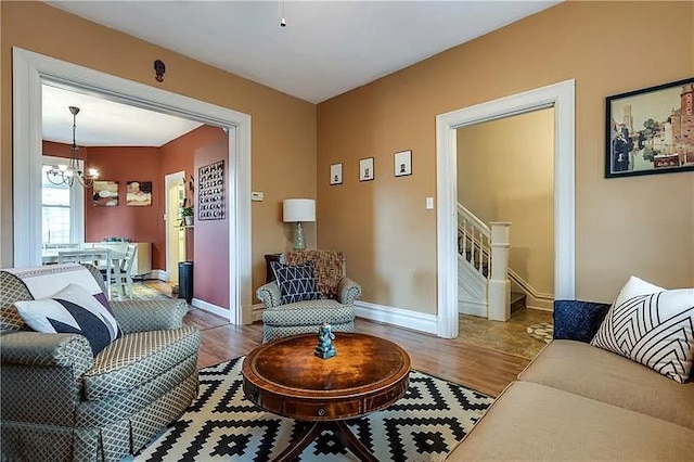 living room featuring hardwood / wood-style floors and a chandelier