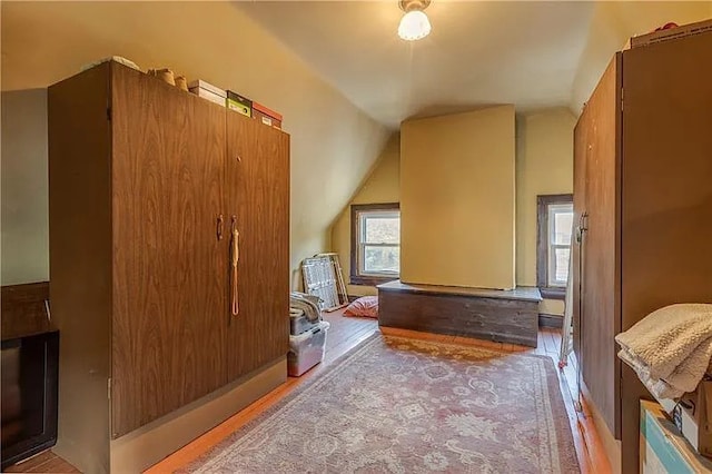 bonus room featuring light hardwood / wood-style flooring and vaulted ceiling