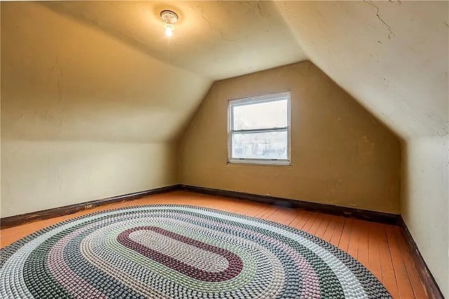 bonus room featuring light hardwood / wood-style flooring and lofted ceiling