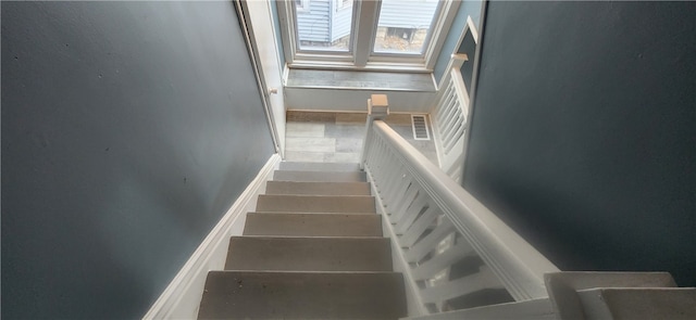 stairway with tile patterned flooring