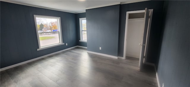 unfurnished bedroom with ornamental molding, hardwood / wood-style flooring, and a closet