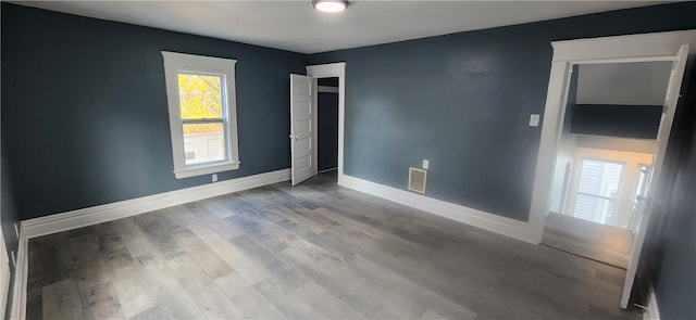 empty room with light hardwood / wood-style flooring