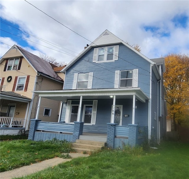 view of front of house with a porch and a front yard