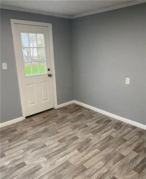 entryway with hardwood / wood-style flooring and ornamental molding