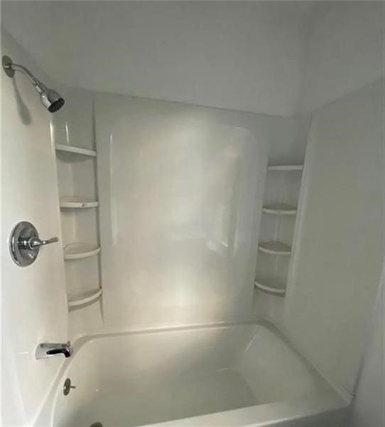 bathroom with shower / washtub combination