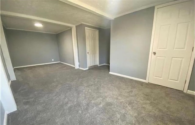 unfurnished bedroom featuring dark carpet and ornamental molding