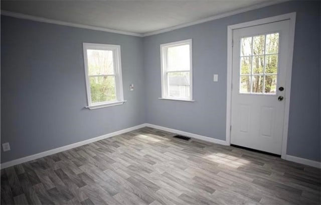 interior space with ornamental molding and dark wood-type flooring