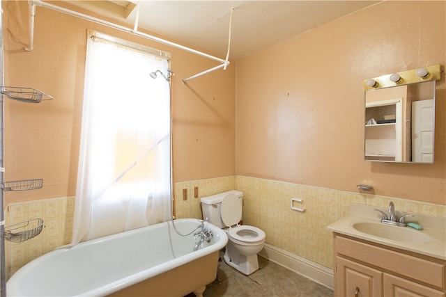 bathroom featuring toilet, vanity, a bath, and tile walls