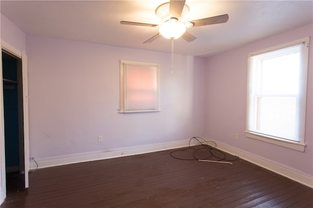 spare room featuring dark wood-type flooring and ceiling fan