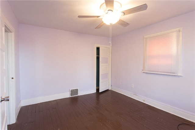 unfurnished room with dark hardwood / wood-style flooring and ceiling fan