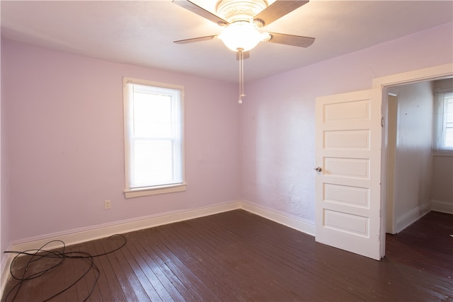 unfurnished room featuring dark wood-type flooring and ceiling fan