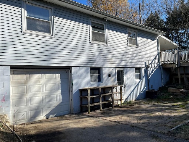 back of property featuring a garage