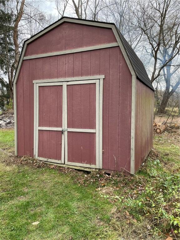 view of outbuilding featuring a lawn