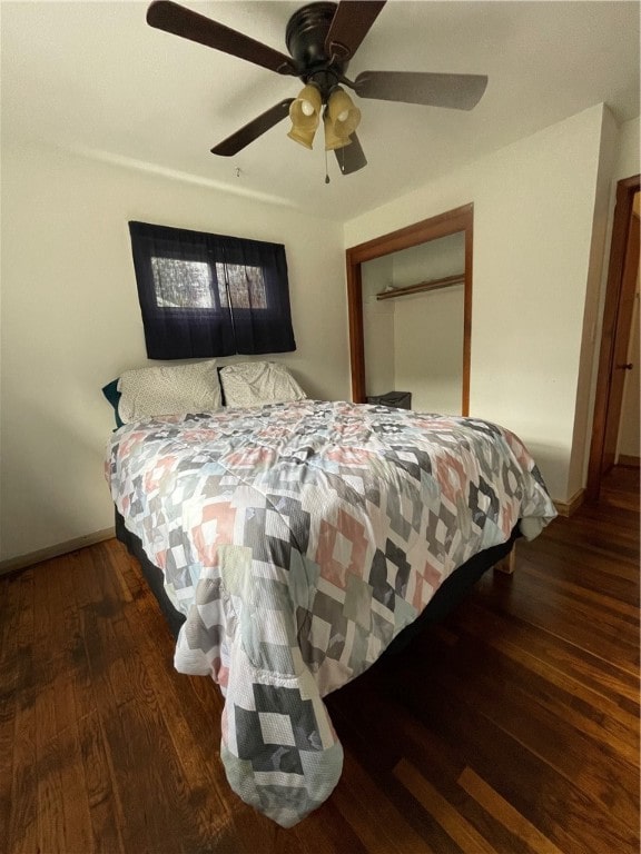 bedroom featuring ceiling fan, a closet, and dark hardwood / wood-style flooring