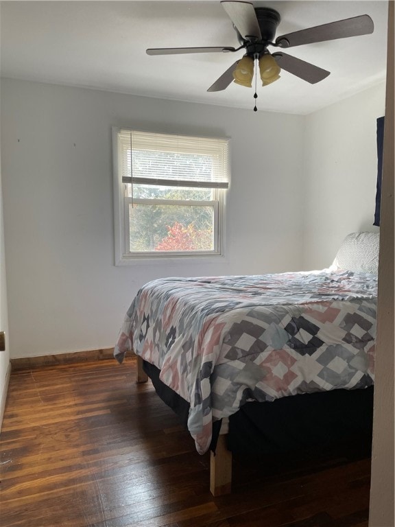 bedroom featuring ceiling fan and dark hardwood / wood-style floors