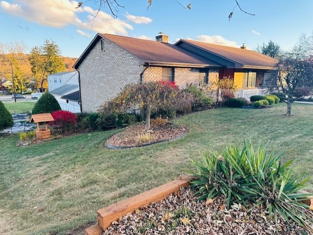 view of side of home with a lawn