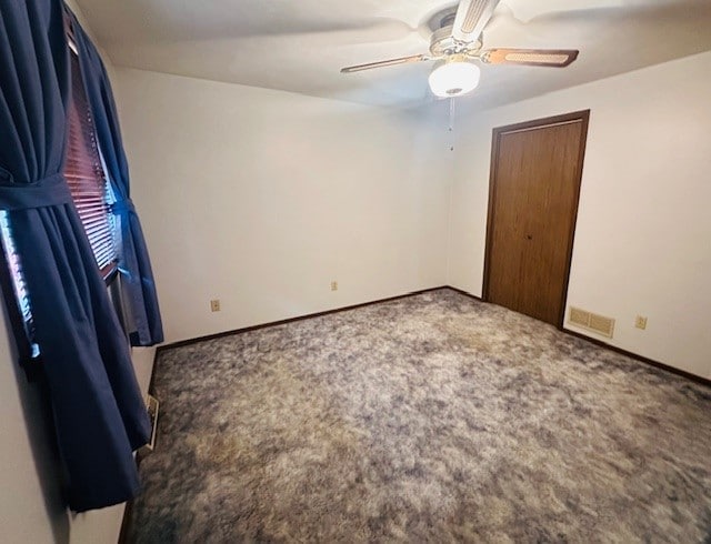 unfurnished bedroom with carpet and ceiling fan