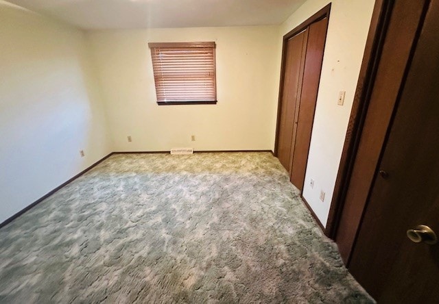 unfurnished bedroom with light colored carpet