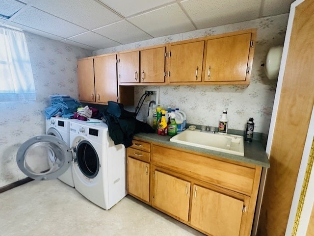 washroom featuring washer and clothes dryer, cabinets, and sink