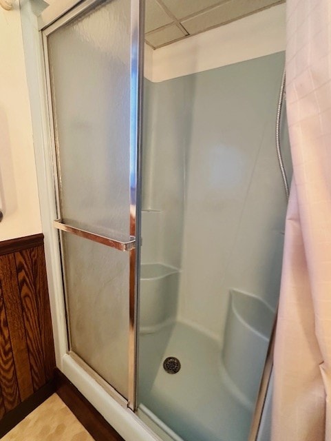 bathroom with a shower with door