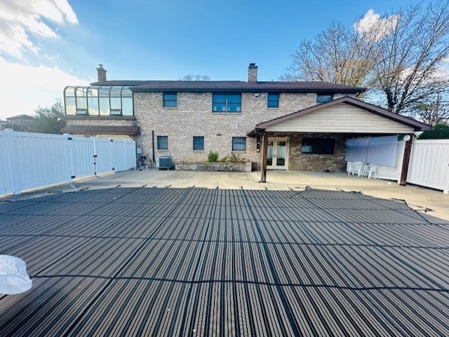 back of house with a patio area and central AC