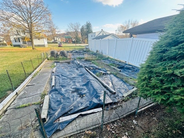 view of pool featuring a lawn