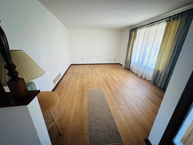 spare room with light hardwood / wood-style flooring