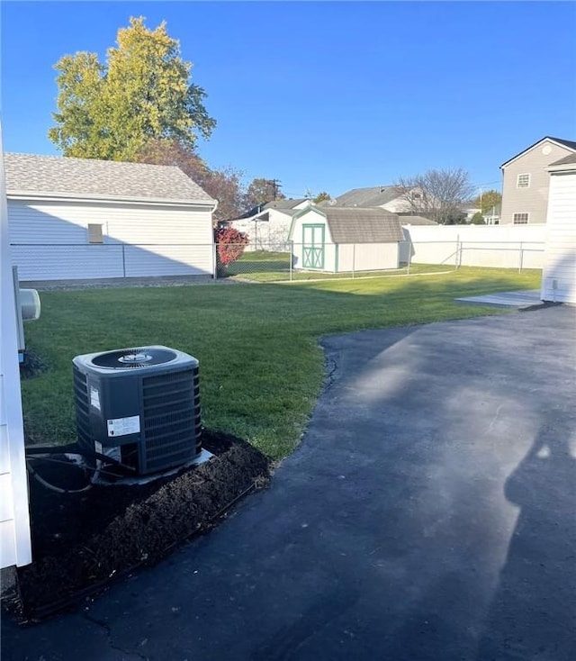 view of yard with a shed and central air condition unit