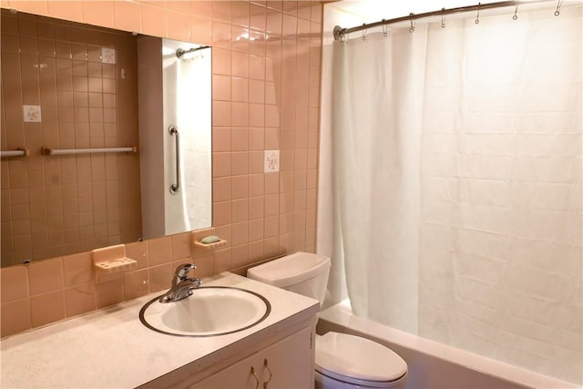 full bathroom featuring vanity, toilet, backsplash, and shower / tub combo