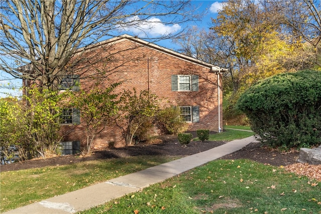 view of property exterior featuring a lawn