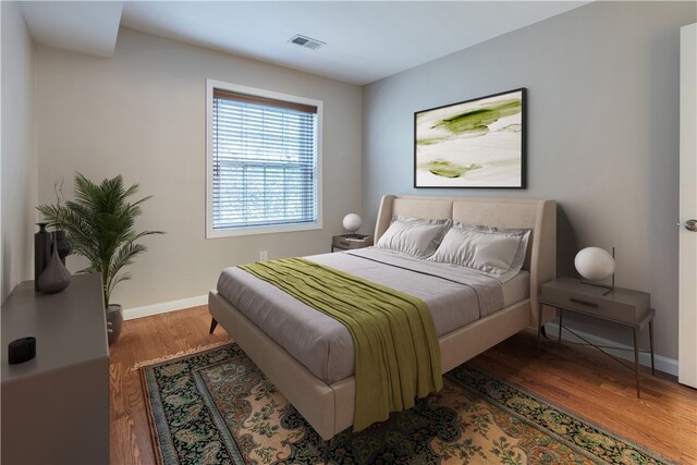 bedroom with dark wood-type flooring