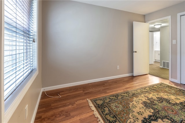 unfurnished room featuring wood-type flooring